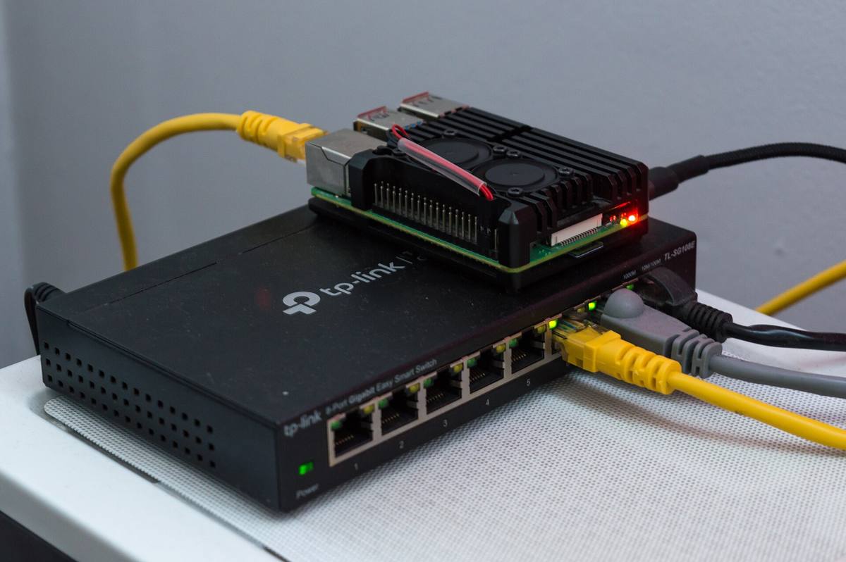 Raspberry Pi 4 položený na osmiportovém síťovém přepínači